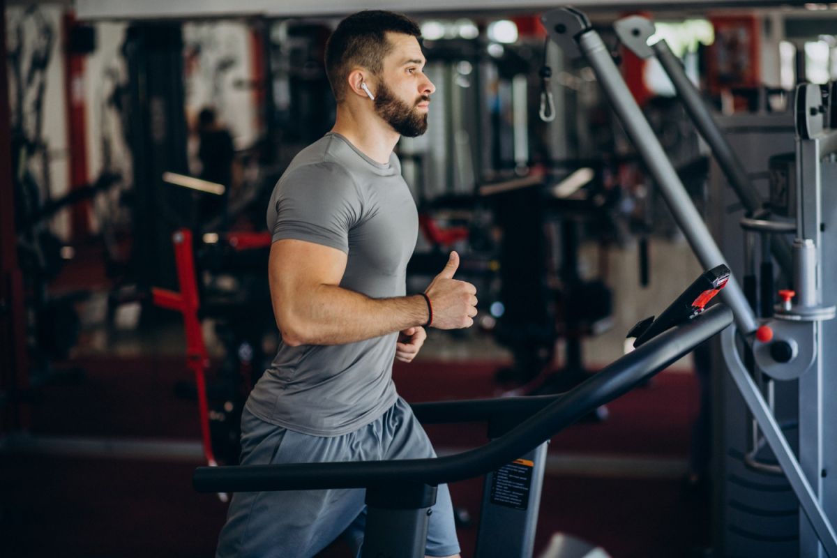 A person running on a treadmill, demonstrating dedication to stay fit at the gym